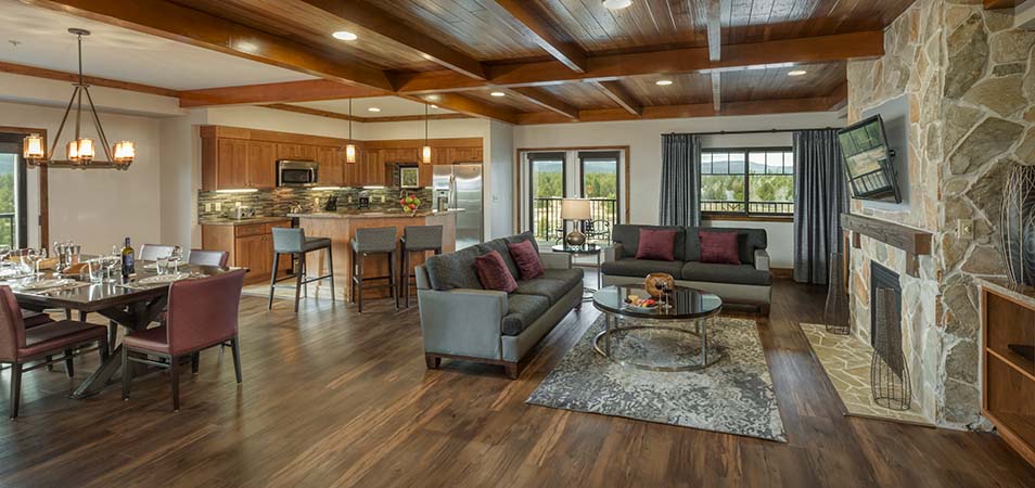 A kitchen, dining, and living area in a Wyndham Destinations Vacation Club resort suite. 